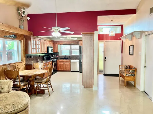 a dining room with furniture a chandelier and window