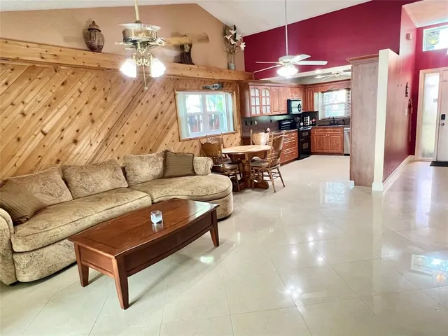 a living room with furniture and a kitchen