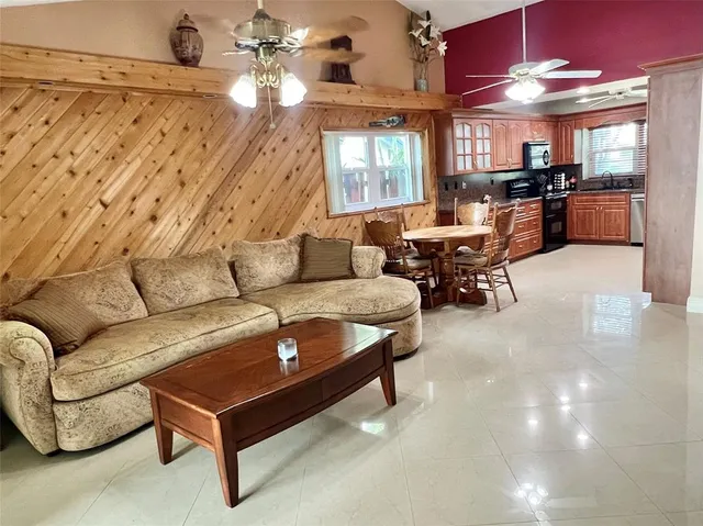 a living room with furniture and chandelier