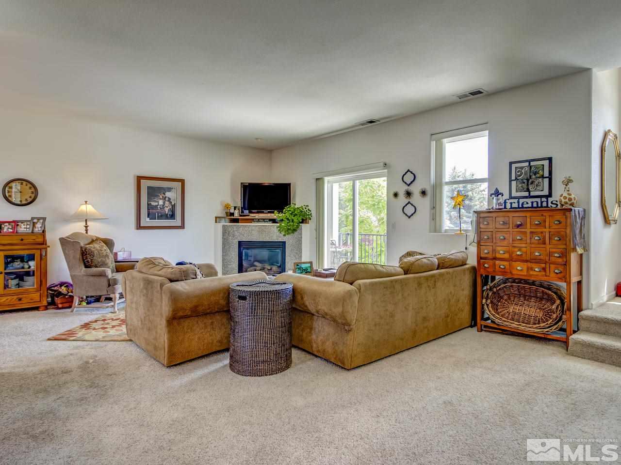785 Stewart Street Reno, NV 89502 - Photo 3 of 25 a living room with furniture a fireplace and a flat screen tv