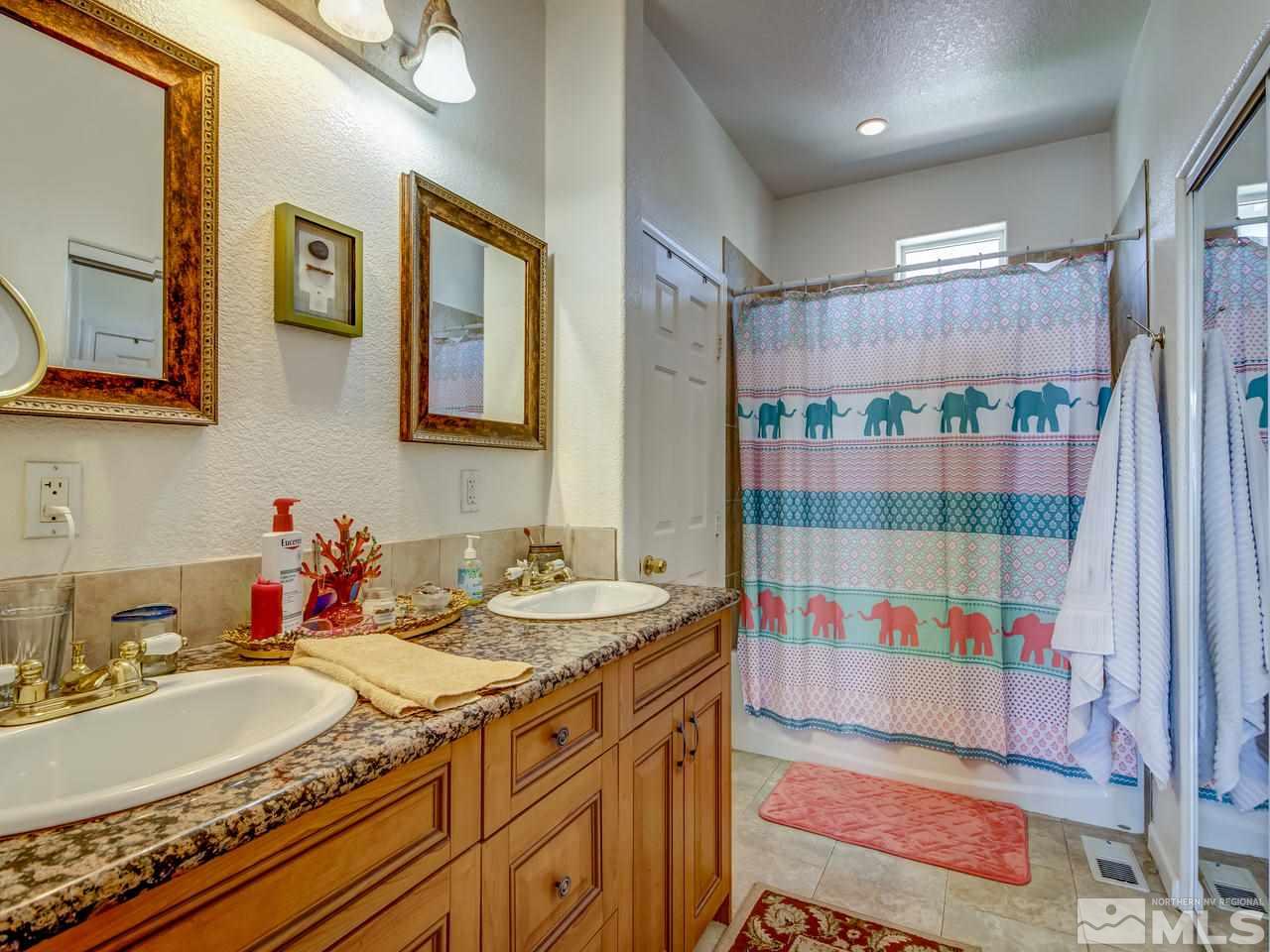 785 Stewart Street Reno, NV 89502 - Photo 8 of 25 a bathroom with a sink and a mirror