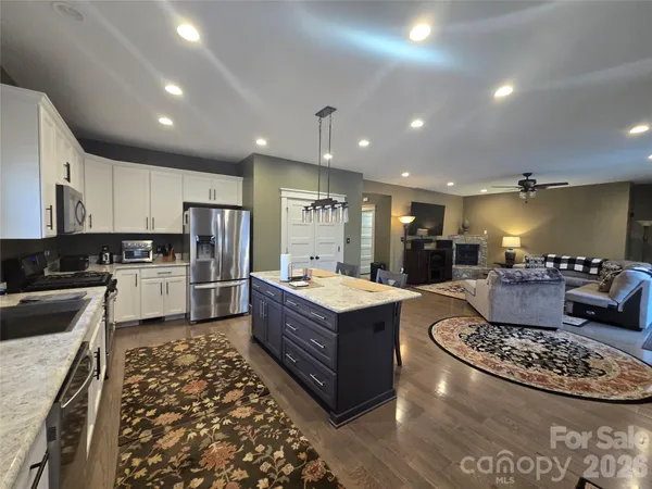 a kitchen with a table chairs a sink and a refrigerator