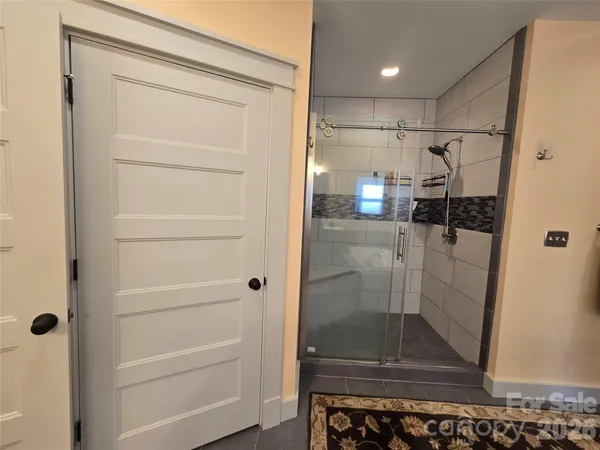 a bathroom with a toilet and a shower