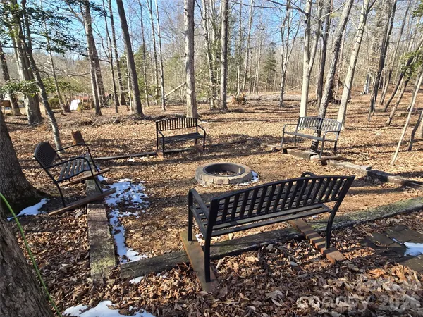 a view of a chairs and table in backyard