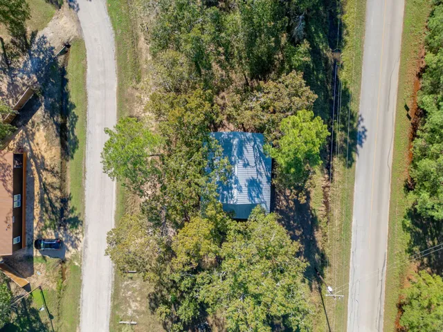 an aerial view of a house with a yard