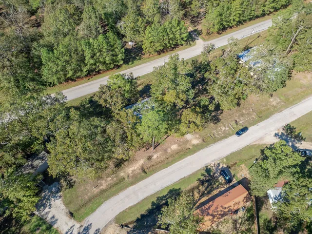 a view of a yard with wooden fence