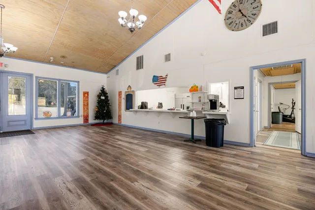 a room with lots of furniture and a large window