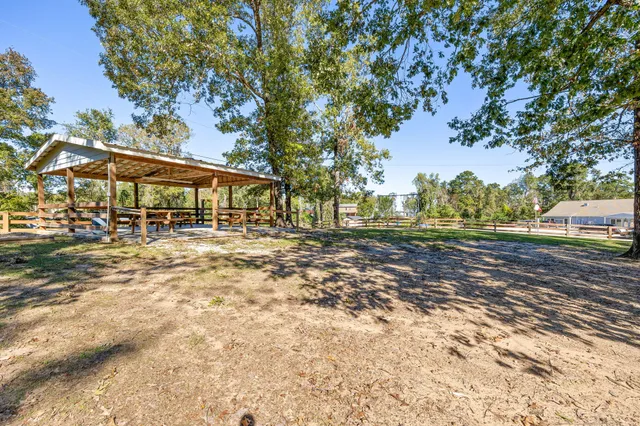a view of a backyard with iron fence