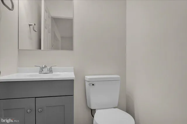 a bathroom with a toilet a sink and mirror