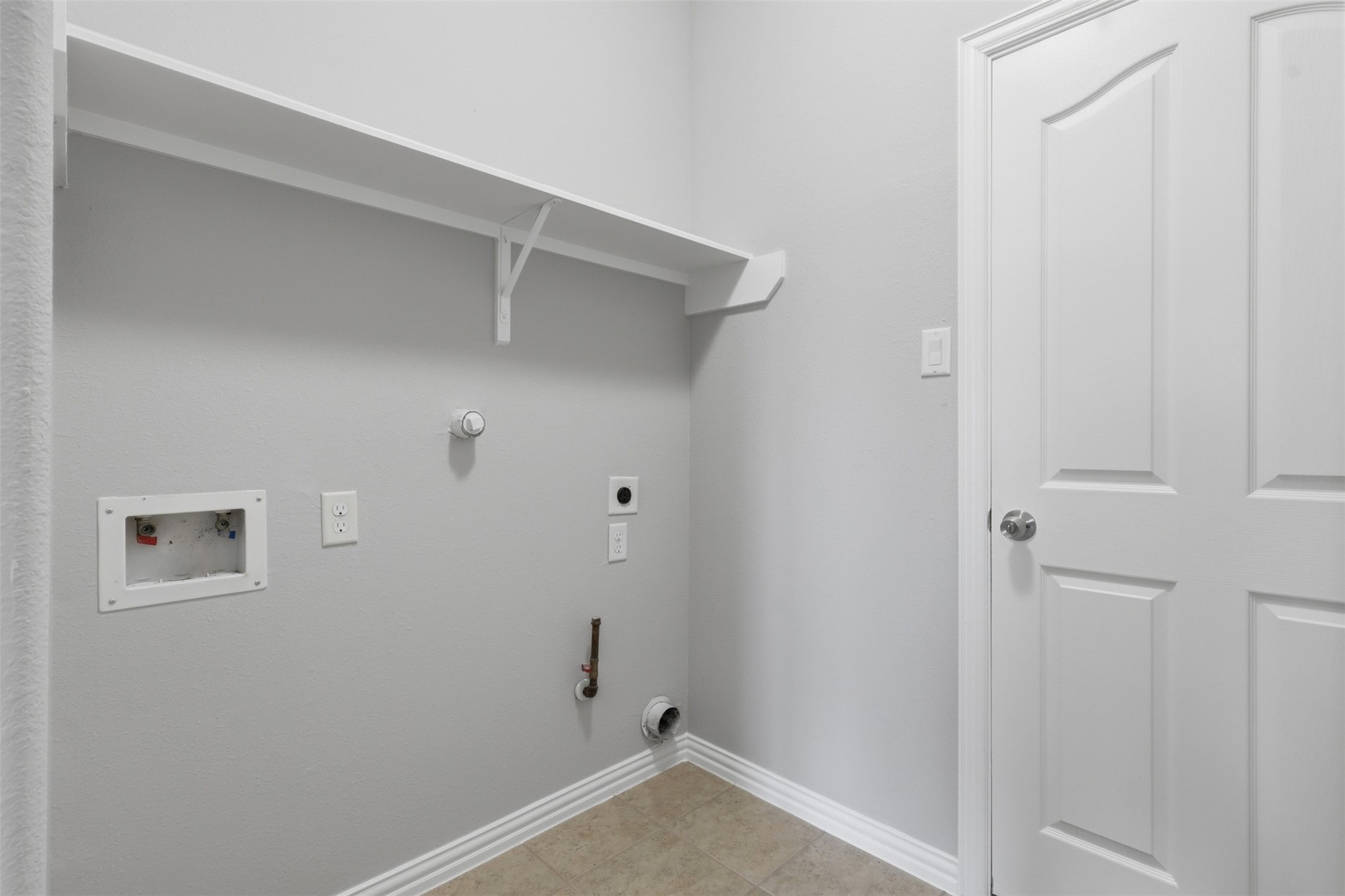25926 Morgan Springs Spring, TX 77373 - Photo 18 of 49 Convenient utility room is located on the first floor off the garage entry and offers washer and gas or electric dryer connections, built-in storage space, and easy access to simplify everyday household tasks.