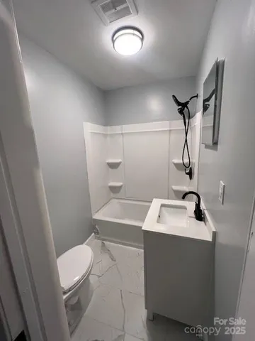 a bathroom with a sink toilet and mirror
