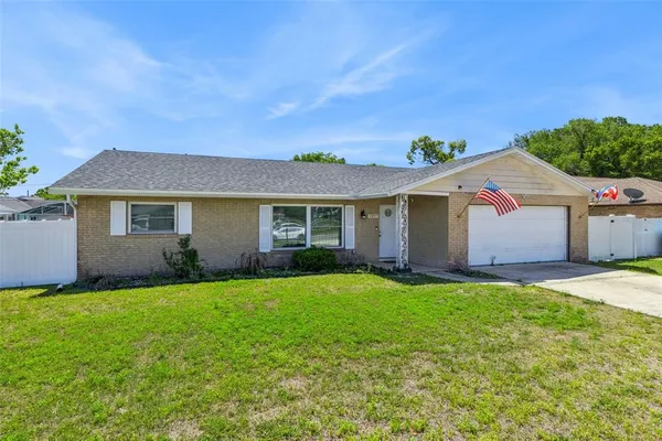 a view of a house with a yard and garage