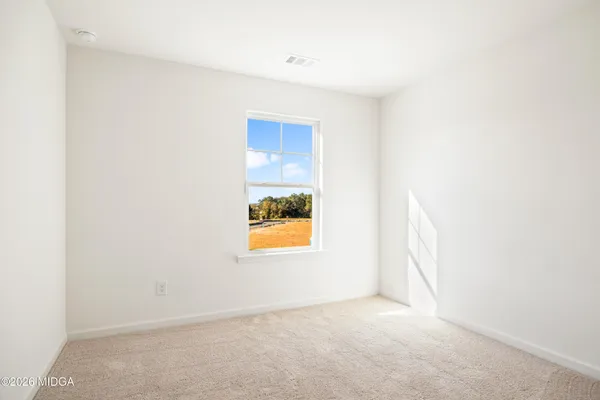 a view of an empty room and a window