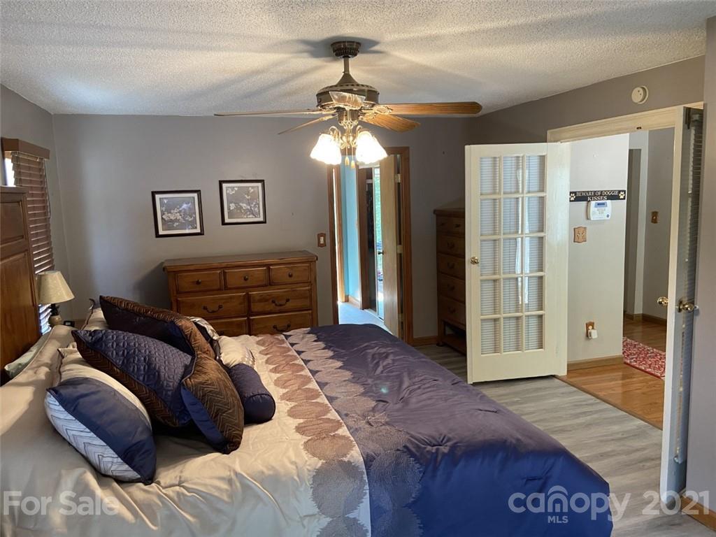433 Foster Lake Road Blacksburg, SC 29702 - Photo 14 of 40 a bedroom with a bed and a chandelier