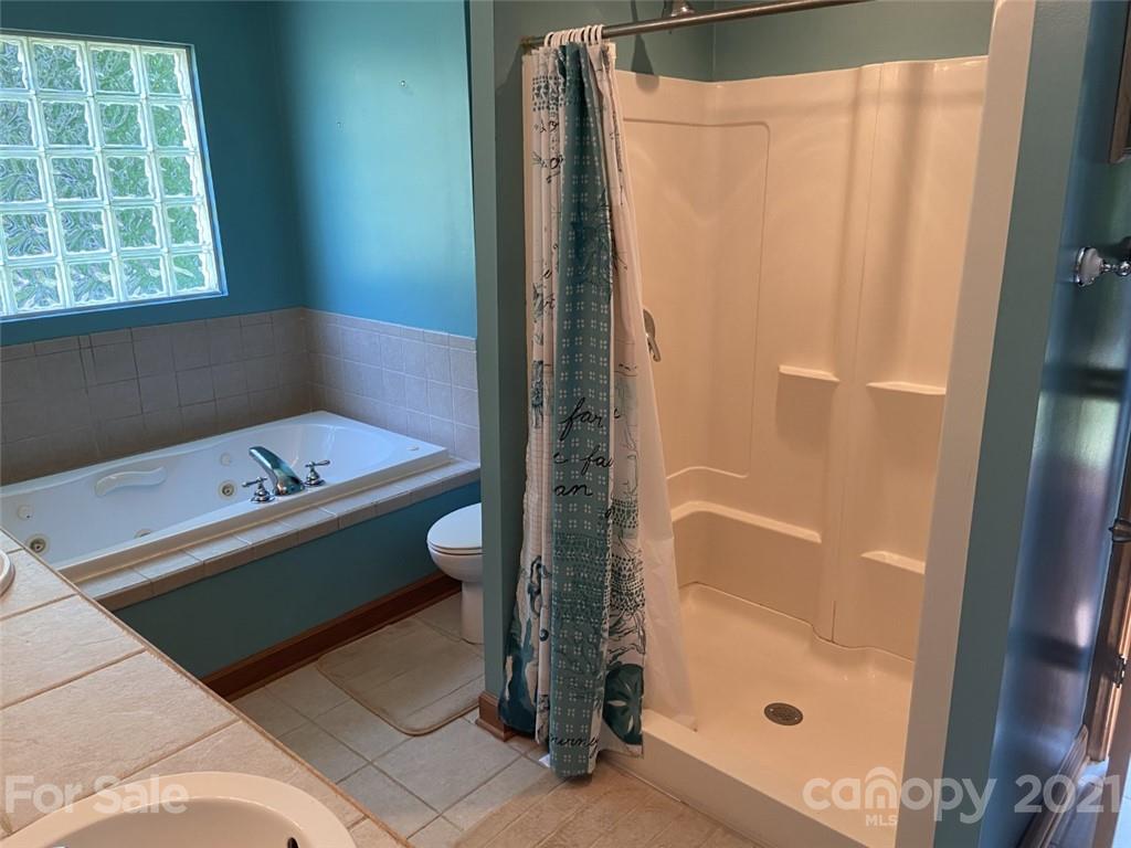 433 Foster Lake Road Blacksburg, SC 29702 - Photo 18 of 40 a bathroom with a bathtub and a shower