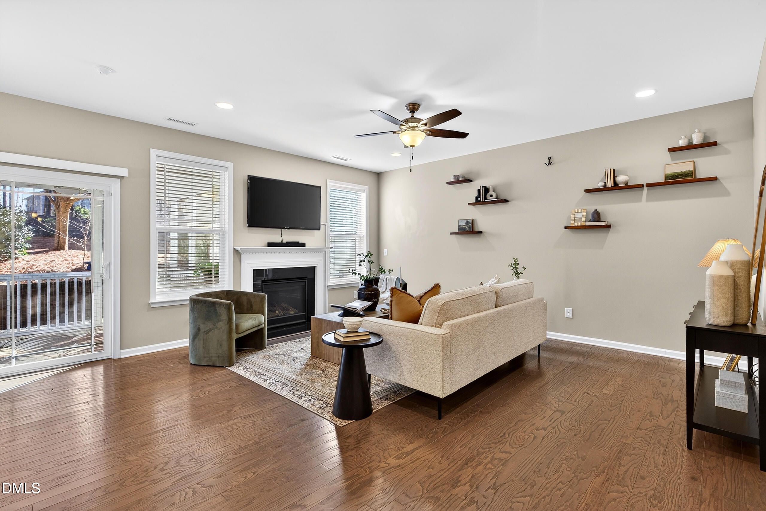 109 Willow View Lane Apex, NC 27539 - Photo 19 of 72 a living room with furniture a fireplace and a flat screen tv