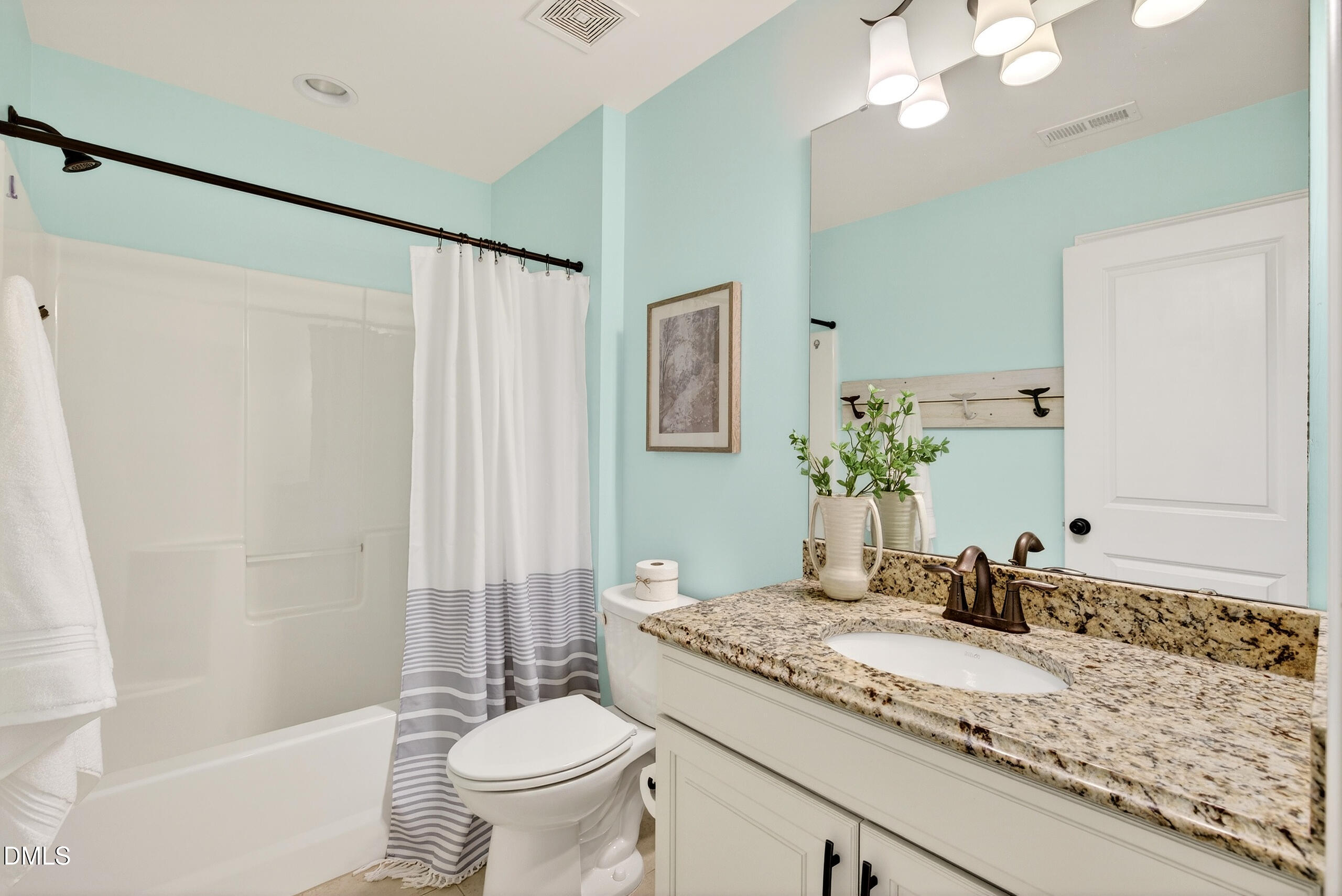 109 Willow View Lane Apex, NC 27539 - Photo 32 of 72 a bathroom with a granite countertop sink a toilet and a mirror