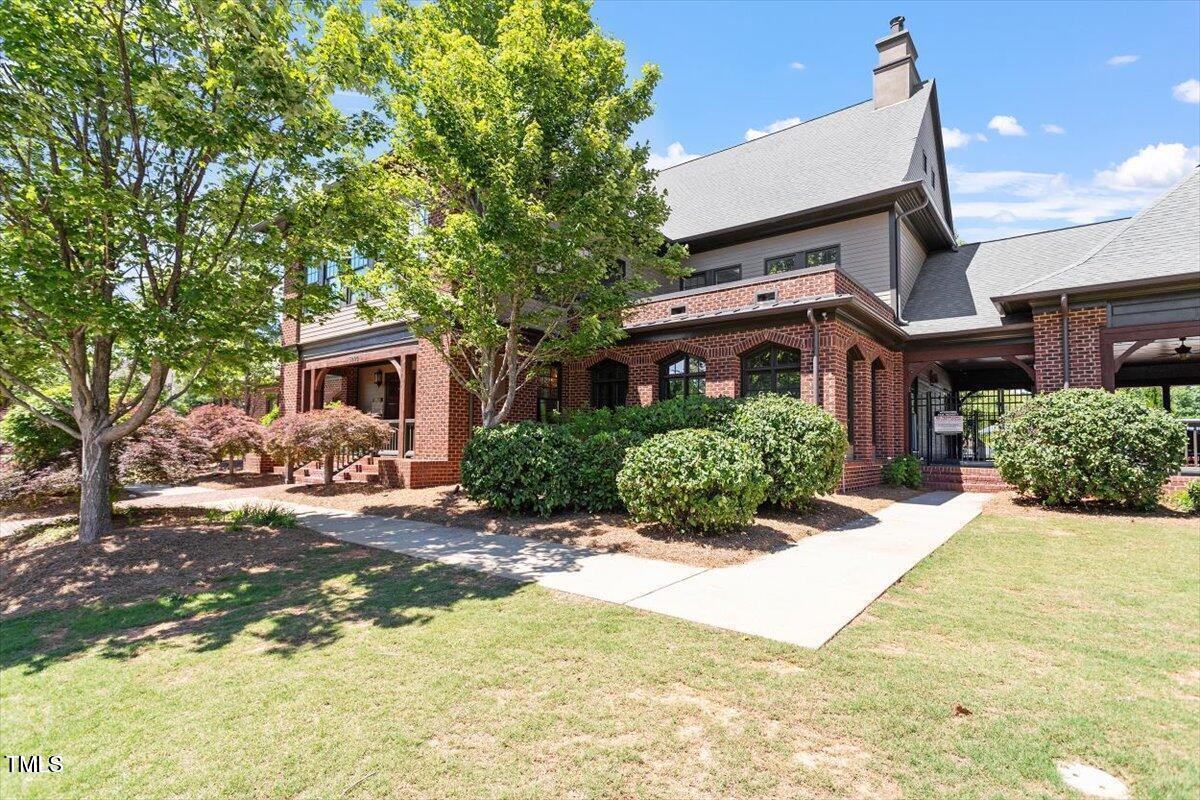 109 Willow View Lane Apex, NC 27539 - Photo 55 of 72 a front view of a house with a yard and potted plants