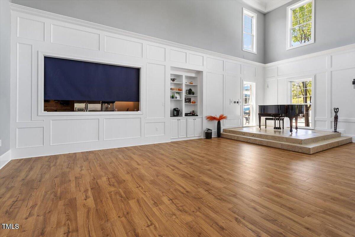 109 Willow View Lane Apex, NC 27539 - Photo 63 of 72 a view of a living room and kitchen with furniture wooden floor and window