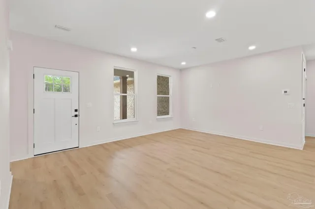 a view of kitchen with kitchen island and stainless steel appliances