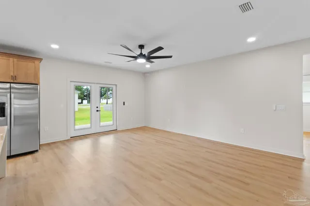 a kitchen with kitchen island a sink appliances and cabinets