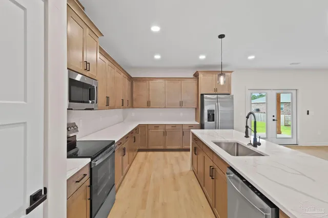 a kitchen with a sink a counter and a dining table