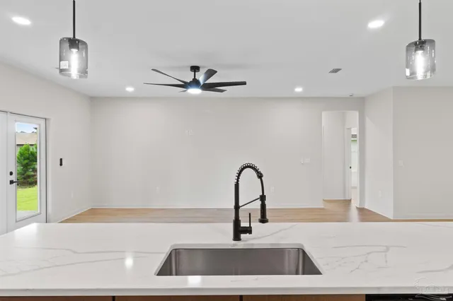 a kitchen with a sink a counter top space stainless steel appliances and cabinets