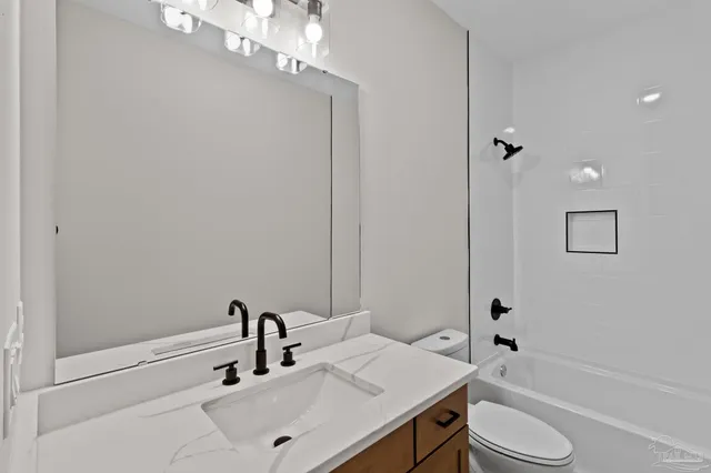 an empty room with windows and ceiling fan