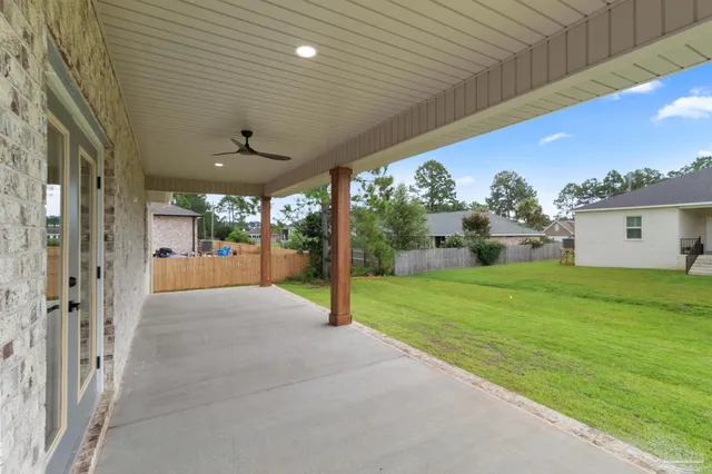 a view of a house with a yard and tree