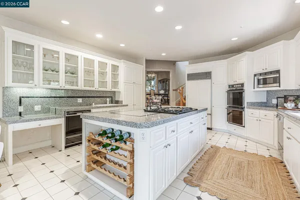 a kitchen with stainless steel appliances granite countertop a stove and a sink