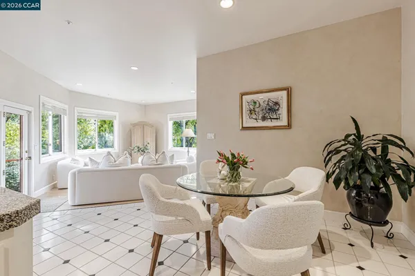 a living room with furniture kitchen and a large window