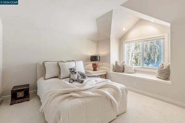 a bed with a white bed and a night stand