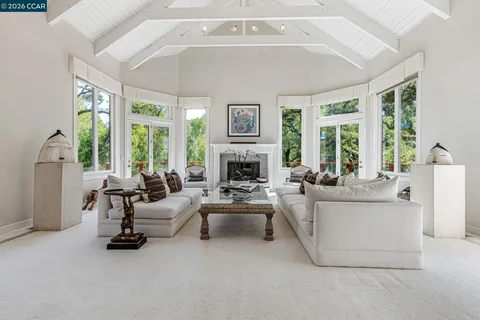 a living room with furniture and large windows