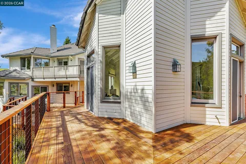 a view of balcony with wooden floor and fence
