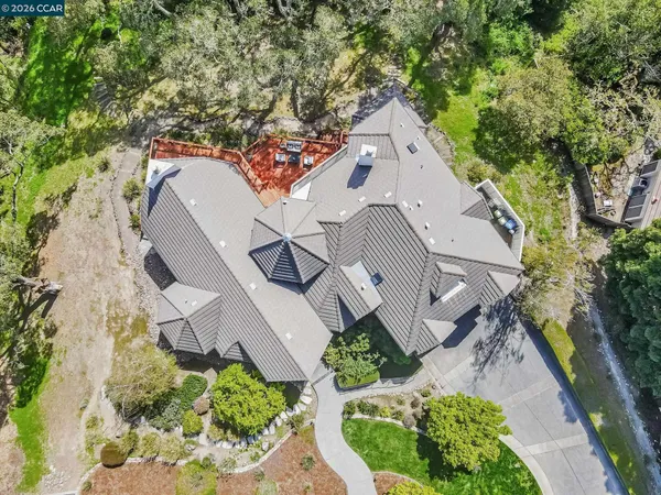 an aerial view of a house with a yard and garden