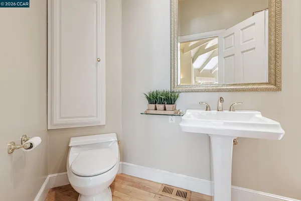 a bathroom with a sink toilet and a mirror