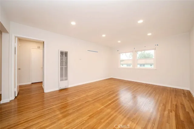 a view of an empty room and wooden floor