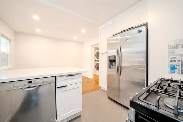 a kitchen with a refrigerator and a stove