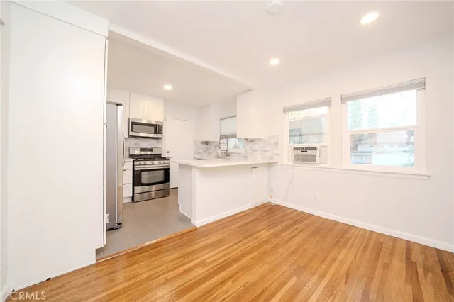 a room with a window and wooden floor