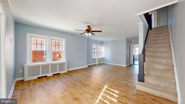 a view of a livingroom with a ceiling fan and window