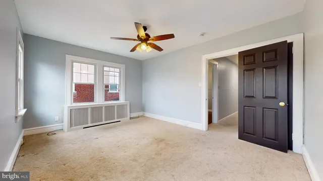 a view of a big room with wooden floor and chandelier fan