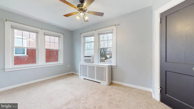 a view of room with window and a ceiling fan
