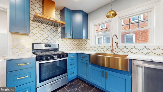 a kitchen with stainless steel appliances granite countertop a sink and wooden cabinets