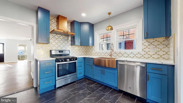 a kitchen with stainless steel appliances granite countertop a refrigerator and a stove