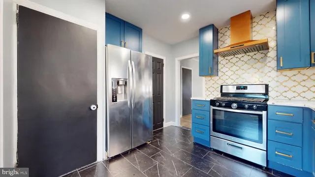 a kitchen with stainless steel appliances granite countertop a refrigerator and a sink