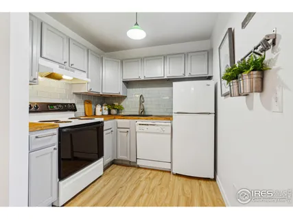 a kitchen with a refrigerator a stove a sink a microwave and cabinets