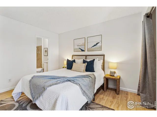 a bedroom with a bed and a night stand