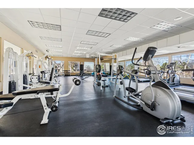 a living room with furniture a flat screen tv and kitchen view