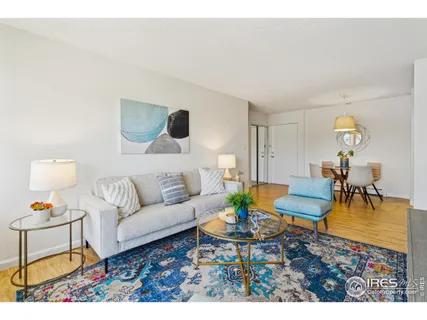 a living room with furniture a rug and a table