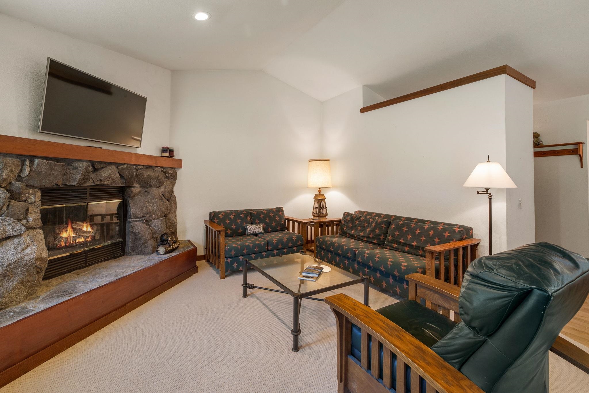1591 Olympic Vly Road, Unit 29 Olympic Valley, CA 96146 - Photo 11 of 28 a living room with furniture and a fireplace